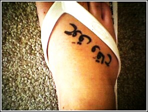 Arabic script name tattoo design on foot