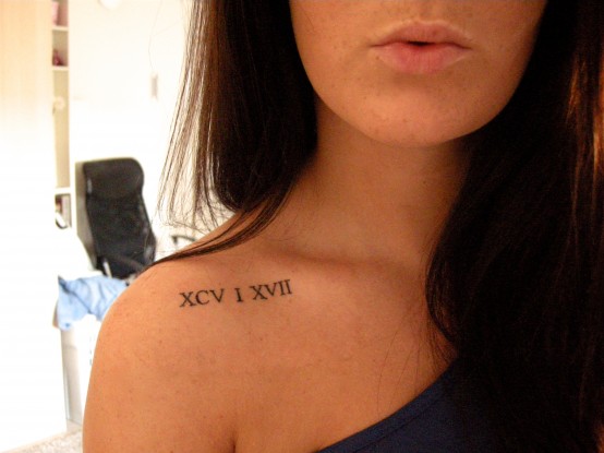 Roman numerals tattoo idea on collar bone for woman