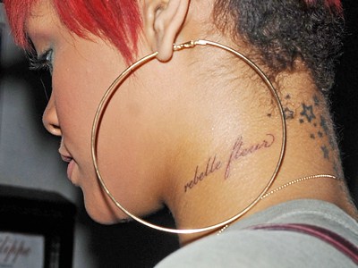Famous Rihanna’s neck tattoo Rebelle Flour