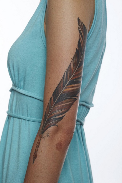 Bird feather tattoo design on arm