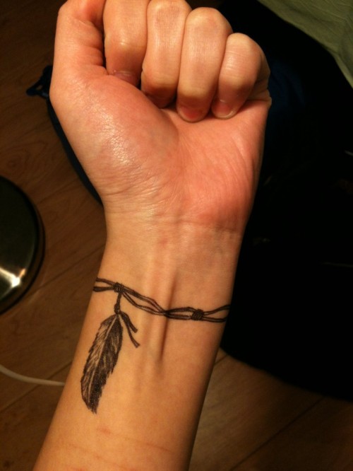Wristband with feather tattoo designs