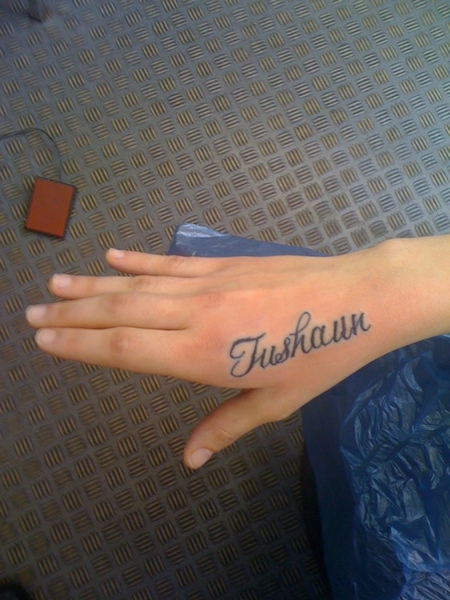 Top of the hand name tattoo idea for woman