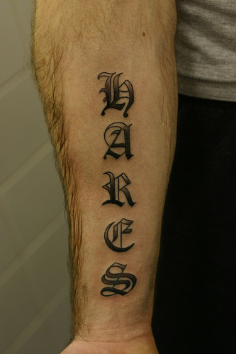 Gothic font name tattoo design arm