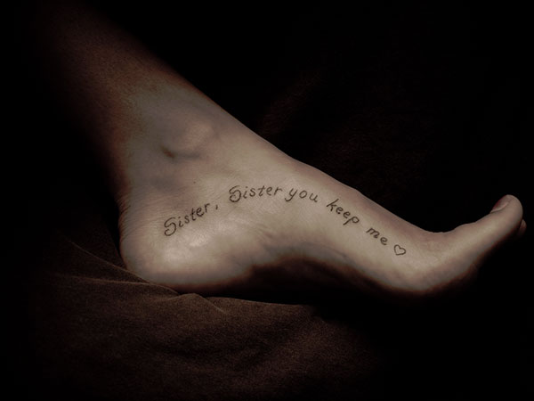 Quote tattoo design on inner part of foot