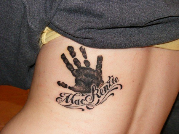 Hand print and baby name tattoo on the back
