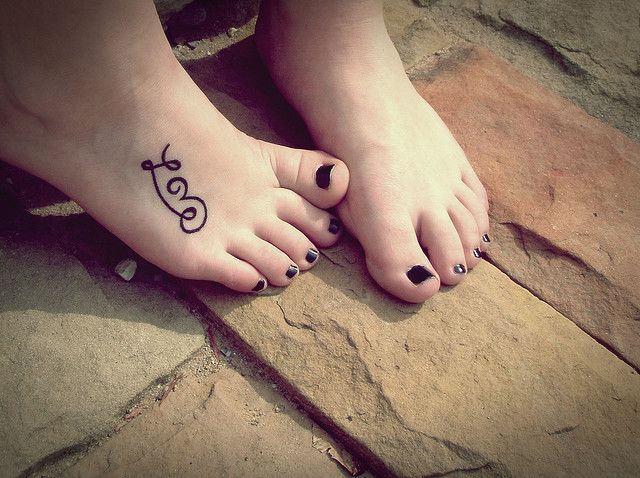 Cute love word name tattoo idea on foot