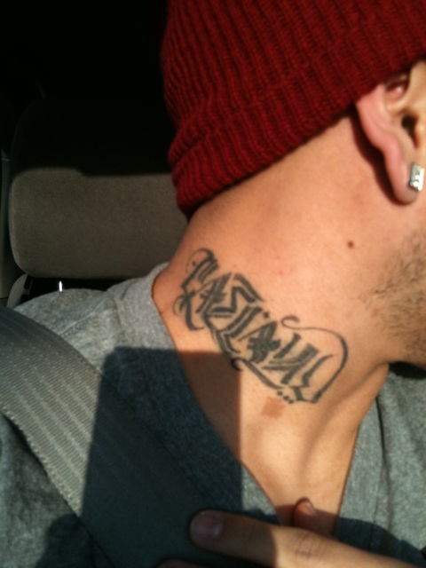 Horizontal name tattoo idea on the neck for man