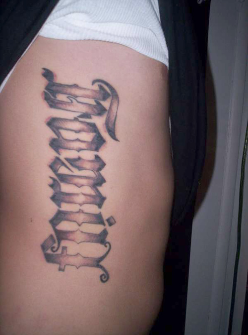 Gothic font name tattoo design on rib cage