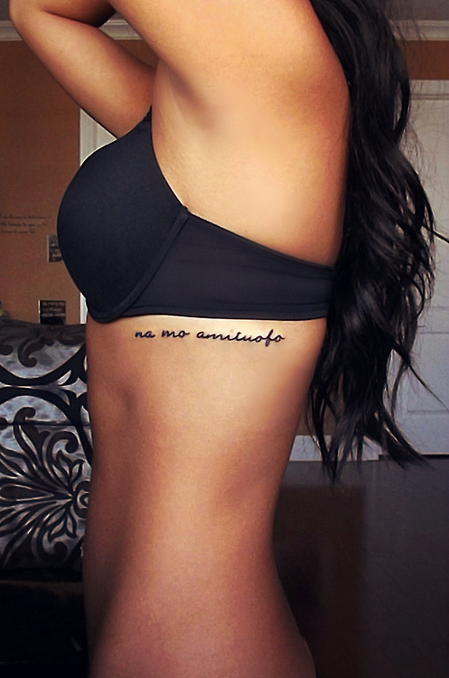 Phrase tattoo idea on the side rib cage for woman