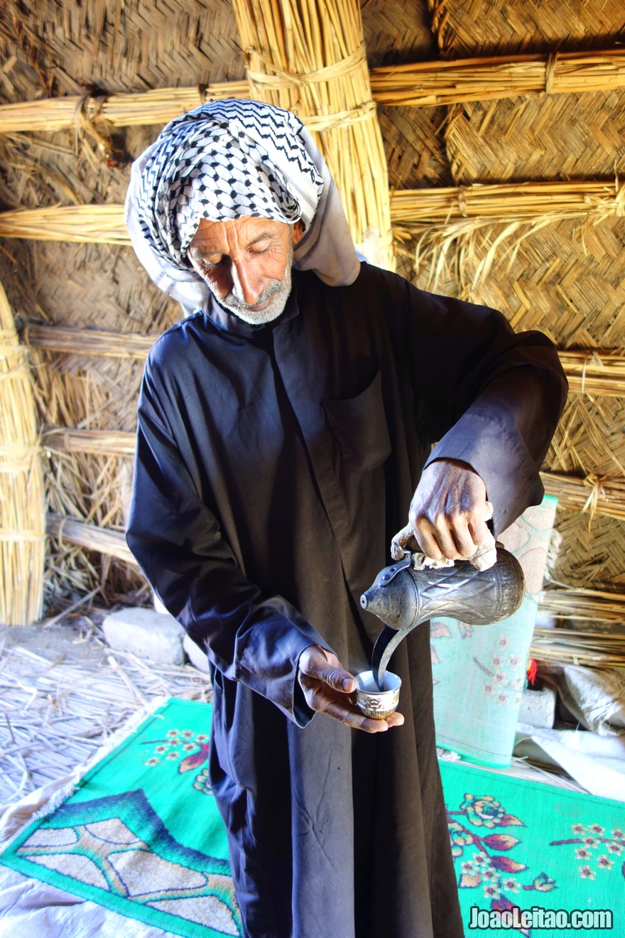 Man serving coffee inside his home