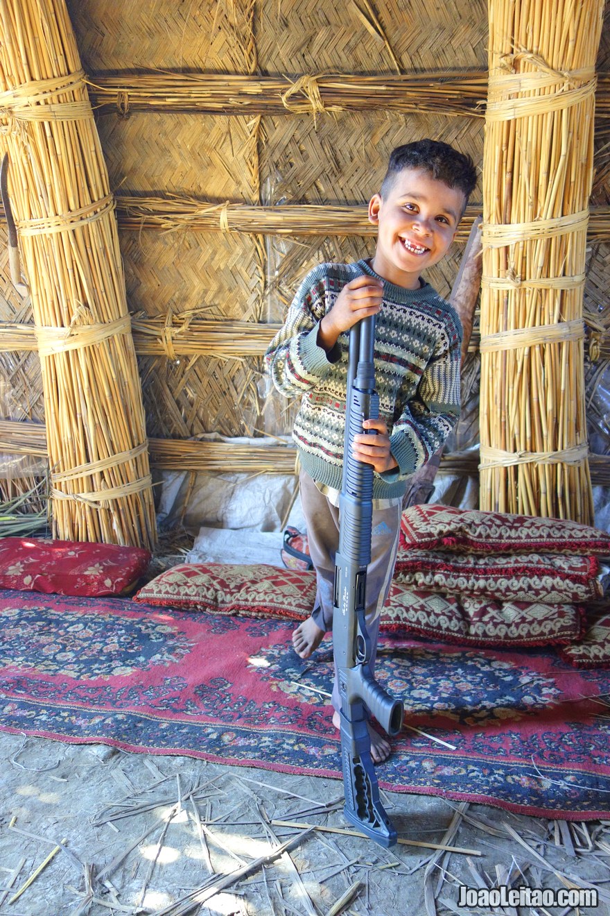 Iraqi boy with a shotgun