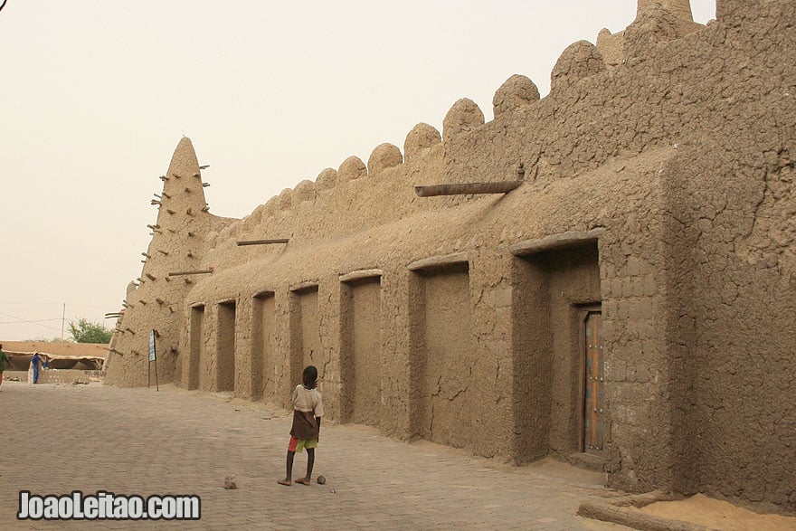 Boy playing football near sacred mosque