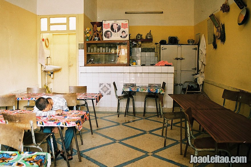 Photo of boy sleeping inside a restaurant, Morocco