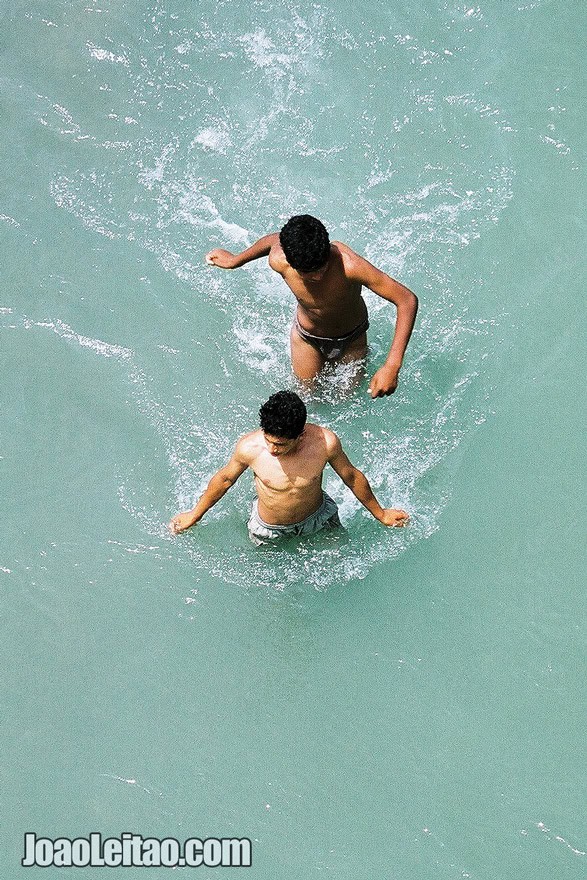 Photo of young men crossing the river, Morocco