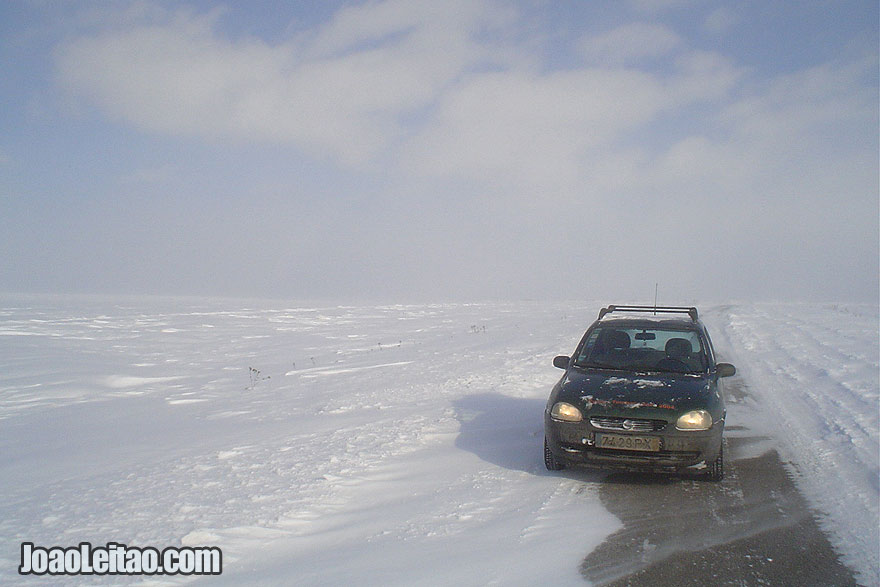 Driving in snow covered empty roads