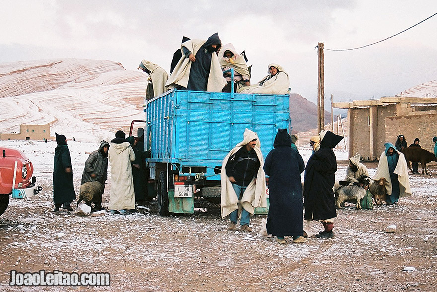Photo of men descending from truck for the Ait Hani morning market, Morocco