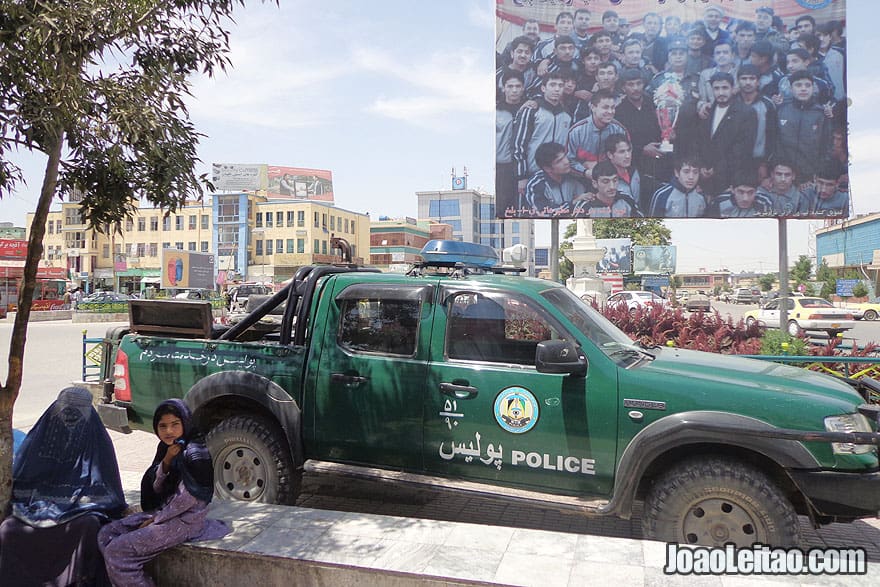 Police car and woman with burqa in the city center