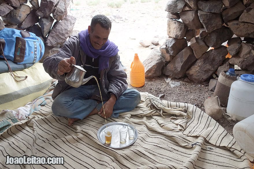 Serving Moroccan tea by friendly man