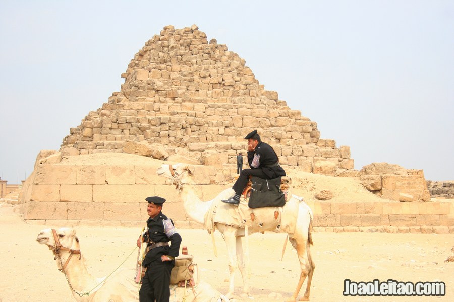 Police officers riding camels