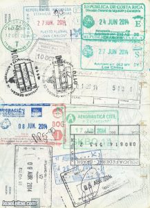 Page of passport full of stamps