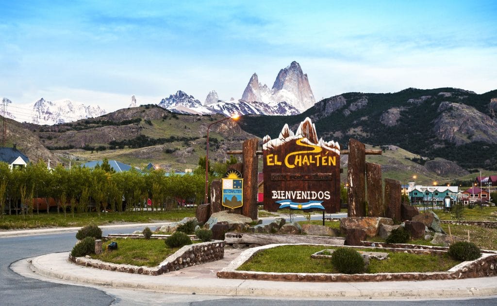 Welcome to El Chalten village sign with Fitz Roy mountain range in the background